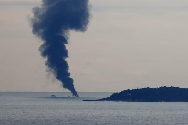 Smoke rises from a 25-meter boat after a fire broke out off Cap d'Antibes, near Nice on February 4, 2025. (Photo by Valery HACHE / AFP)