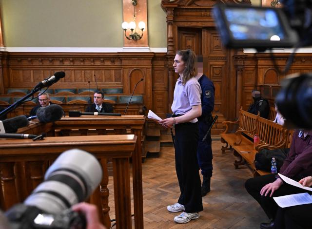 The defendant, German anti-fascist activist Maja T, addresses the court in the courtroom in Budapest on February 4, 2026, as the court is expected to give its verdict in her case for allegedly participating in attacks against presumed neo-Nazis on the streets of the Hungarian capital. A Hungarian court in Budapest is expected to give a verdict on January 4, 2026 in the case of Maja T., a non-binary anti-fascist activist from Germany, who faces up to 24 years in jail on charges of assault in a closely watched and controversial trial. The German constitutional court has slammed the 2024 estradition of Maja T., 25, over potentially dangerous prison conditions in Hungary, especially for LGBTQ people. (Photo by Attila KISBENEDEK / AFP) / EDITORS NOTE: ACCORDING TO COURT'S RULING THE FACES OF THE JUSTICE OFFICERS AND POLICE IN THE COURTROOM MUST BE MADE UNRECOGNIZABLE