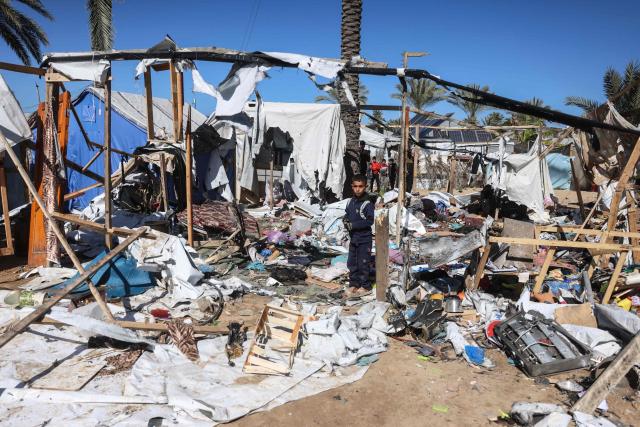 A boy stands amid debris following a reported Israeli strike on a camp housing displaced Palestinians in Khan Yunis in the southern Gaza Strip on February 4, 2026. Despite a US-brokered truce entering its second phase last month, violence has continued in the Gaza Strip, with Israel and Hamas accusing each other of breaching the agreement. (Photo by Bashar Taleb / AFP)