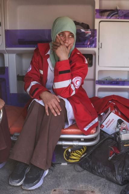 A member of the Palestinian Red Crescent mourns during the funeral of a colleague who was reportedly killed in an Israeli strike on a camp housing displaced Palestinians, in Khan Yunis in the southern Gaza Strip on February 4, 2026. Gazan health officials said Israeli air strikes on February 4, killed 21 people in the Palestinian territory, with Israel's military saying it struck after gunfire targeting its troops wounded an officer. Despite a US-brokered truce entering its second phase last month, violence has continued in the Gaza Strip, with Israel and Hamas accusing each other of breaching the agreement. (Photo by Bashar Taleb / AFP)