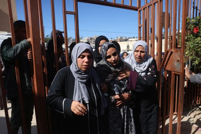 Women mourn during the funeral of a Palestinian Red Crescent member and two children who were reportedly killed in an Israeli strike on a camp housing displaced Palestinians, in Khan Yunis in the southern Gaza Strip on February 4, 2026. Gazan health officials said Israeli air strikes on February 4, killed 21 people in the Palestinian territory, with Israel's military saying it struck after gunfire targeting its troops wounded an officer. Despite a US-brokered truce entering its second phase last month, violence has continued in the Gaza Strip, with Israel and Hamas accusing each other of breaching the agreement. (Photo by Bashar Taleb / AFP)