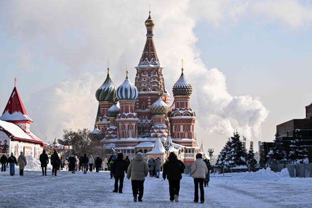Tourists walk on Red Square in front of St. Basil's cathedral in central Moscow on February 4, 2026. (Photo by Hector RETAMAL / AFP)