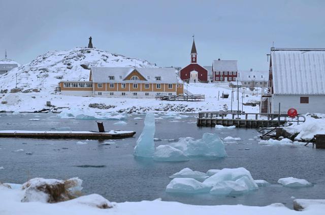 Floating ice is seen in front of residential buildings in the city of Nuuk, western Greenland, on February 4, 2026. (Photo by Ina FASSBENDER / AFP)