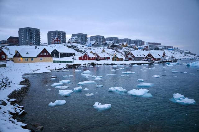 Floating ice is seen in front of residential buildings in the city of Nuuk, western Greenland, on February 4, 2026. (Photo by Ina FASSBENDER / AFP)