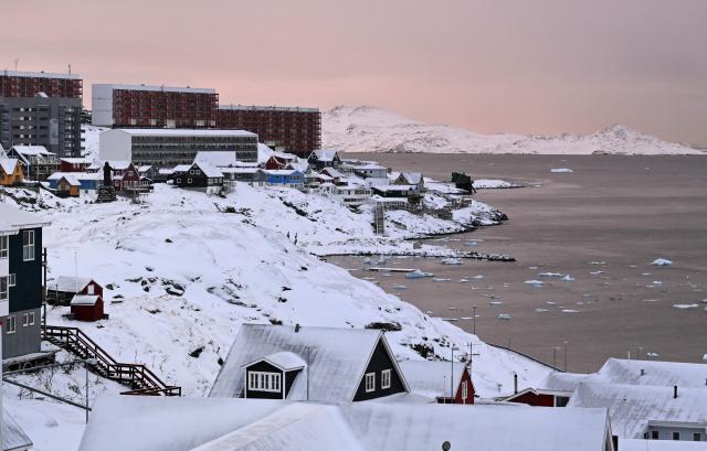 Apartment buildings are pictured at the coastline in Nuuk, western Greenland, on February 4, 2026. (Photo by Ina FASSBENDER / AFP)