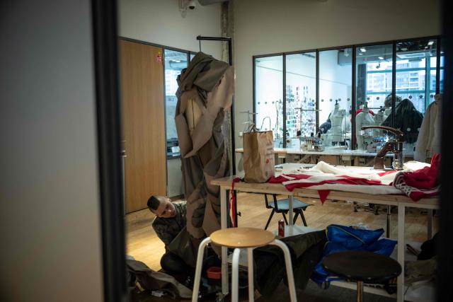A fashion student works on his project in a classroom of the Institut Francais de la Mode in Paris on January 27, 2026. The Institut Francais de la Mode is one of the world's leading fashion schools, training students from around the globe in the fields of design, management, and craftsmanship. (Photo by JULIEN DE ROSA / AFP)