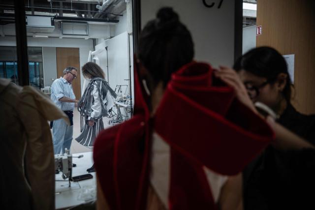 Fashion students work on their undergraduate project before a presentation to a jury at the Institut Francais de la Mode in Paris on January 27, 2026. The Institut Francais de la Mode is one of the world's leading fashion schools, training students from around the globe in the fields of design, management, and craftsmanship. (Photo by JULIEN DE ROSA / AFP)