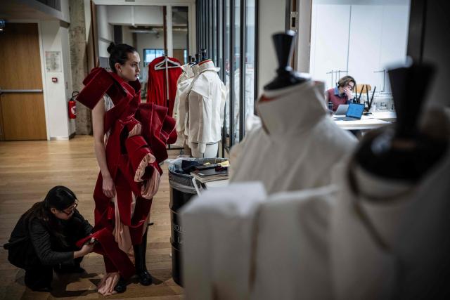 A fashion student works on her undergraduate project before a presentation to a jury at the Institut Francais de la Mode in Paris on January 27, 2026. The Institut Francais de la Mode is one of the world's leading fashion schools, training students from around the globe in the fields of design, management, and craftsmanship. (Photo by JULIEN DE ROSA / AFP)