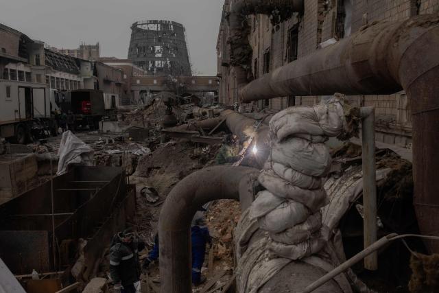 Employees repair sections of the Darnytska combined heat and power plant damaged by Russian air strikes in Kyiv, on February 4, 2026, amid the Russian invasion of Ukraine. Recent Russian strikes on Ukraine's power infrastructure have disrupted light, heating and water supplies to millions across the country as temperatures plummet well below freezing, leaving the war-battered country facing a fresh humanitarian crisis. (Photo by Roman PILIPEY / AFP)