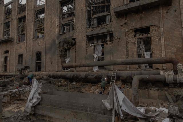 Employees repair sections of the Darnytska combined heat and power plant damaged by Russian air strikes in Kyiv, on February 4, 2026, amid the Russian invasion of Ukraine. Recent Russian strikes on Ukraine's power infrastructure have disrupted light, heating and water supplies to millions across the country as temperatures plummet well below freezing, leaving the war-battered country facing a fresh humanitarian crisis. (Photo by Roman PILIPEY / AFP)