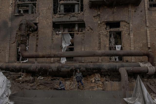 Employees repair sections of the Darnytska combined heat and power plant damaged by Russian air strikes in Kyiv, on February 4, 2026, amid the Russian invasion of Ukraine. Recent Russian strikes on Ukraine's power infrastructure have disrupted light, heating and water supplies to millions across the country as temperatures plummet well below freezing, leaving the war-battered country facing a fresh humanitarian crisis. (Photo by Roman PILIPEY / AFP)