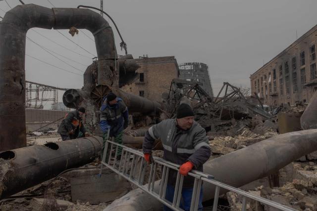 Employees repair sections of the Darnytska combined heat and power plant damaged by Russian air strikes in Kyiv, on February 4, 2026, amid the Russian invasion of Ukraine. Recent Russian strikes on Ukraine's power infrastructure have disrupted light, heating and water supplies to millions across the country as temperatures plummet well below freezing, leaving the war-battered country facing a fresh humanitarian crisis. (Photo by Roman PILIPEY / AFP)