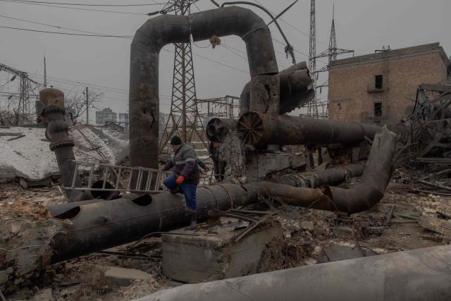 Employees repair sections of the Darnytska combined heat and power plant damaged by Russian air strikes in Kyiv, on February 4, 2026, amid the Russian invasion of Ukraine. Recent Russian strikes on Ukraine's power infrastructure have disrupted light, heating and water supplies to millions across the country as temperatures plummet well below freezing, leaving the war-battered country facing a fresh humanitarian crisis. (Photo by Roman PILIPEY / AFP)