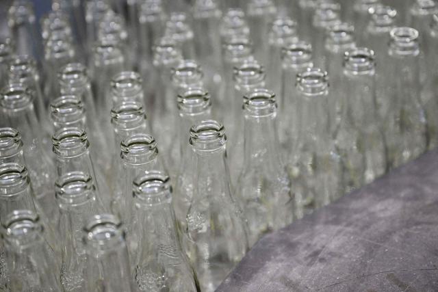 Newly manufactured bottles are pictured at a factory run by British glass containers maker and filler, Encirc, in Elton, north-west England on February 4, 2026. (Photo by Paul ELLIS / AFP)