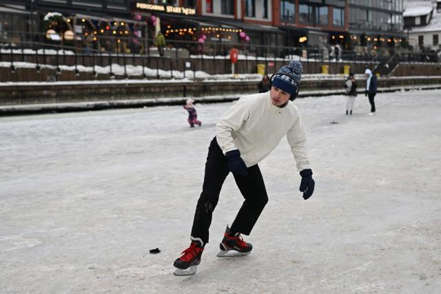 A man skates on the frozen Motlawa River in central Gdansk on February 4, 2026. (Photo by Sergei GAPON / AFP)