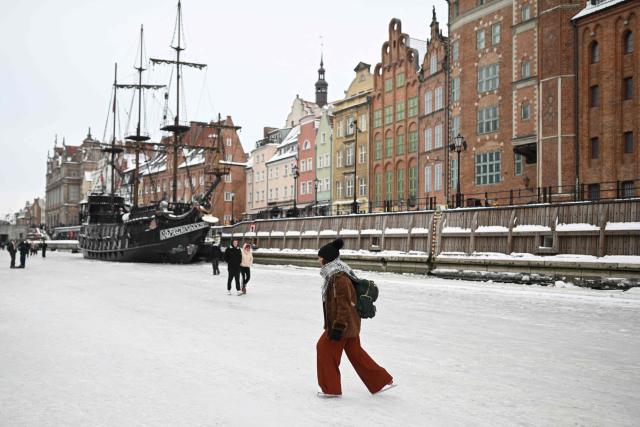 A woman skates on the frozen Motlawa River in central Gdansk on February 4, 2026. (Photo by Sergei GAPON / AFP)