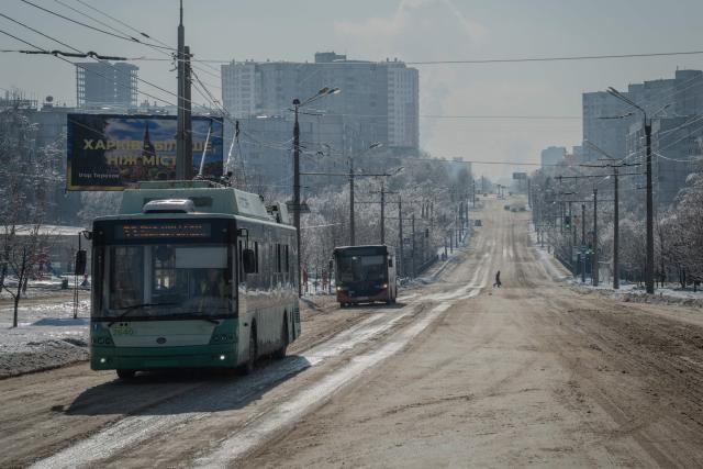 Buses drive down a snow covered road in Kharkiv on February 4, 2026, amid the Russian invasion of Ukraine. (Photo by Ivan SAMOILOV / AFP)