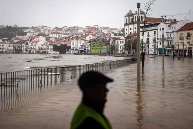 Floodwaters from Sado River cover the streets in Alcacer do Sal, south of Portugal, amid Storm Leonardo on February 4, 2026. A storm unleashing up to 35 centimetres (14 inches) of rain in 24 hours battered the Iberian Peninsula today, forcing thousands of people in southern Spain from their homes, shutting schools and cancelling trains. Leonardo compounded difficulties for residents in Portugal who were already reeling from last week's Storm Kristin, which killed five people, injured hundreds and cut off tens of thousands of customers from the power grid. (Photo by PATRICIA DE MELO MOREIRA / AFP)