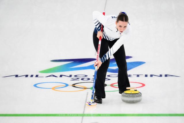 Czech Republic's Julie Zelingrova sweeps as she competes in the curling mixed doubles round robin between Canada and Czech Republic during the Milano Cortina 2026 Winter Olympic Games at the Cortina Curling Olympic Stadium in Cortina d’Ampezzo on February 4, 2026. (Photo by Marco BERTORELLO / AFP)