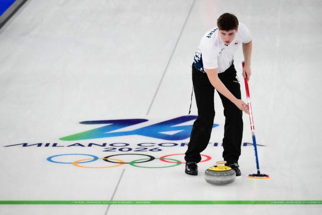 Czech Republic's Vit Chabicovsky sweeps as he competes in the curling mixed doubles round robin between Canada and Czech Republic during the Milano Cortina 2026 Winter Olympic Games at the Cortina Curling Olympic Stadium in Cortina d’Ampezzo on February 4, 2026. (Photo by Marco BERTORELLO / AFP)