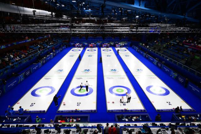 This overview shows a general view of the venue during the curling mixed doubles round robin session 1 between (From L) Estonia and Switzerland, Canada and The Czech Republic, Britain and Norway, Sweden and South Korea during the Milano Cortina 2026 Winter Olympic Games at the Cortina Curling Olympic Stadium in Cortina d’Ampezzo on February 4, 2026. (Photo by Marco BERTORELLO / AFP)