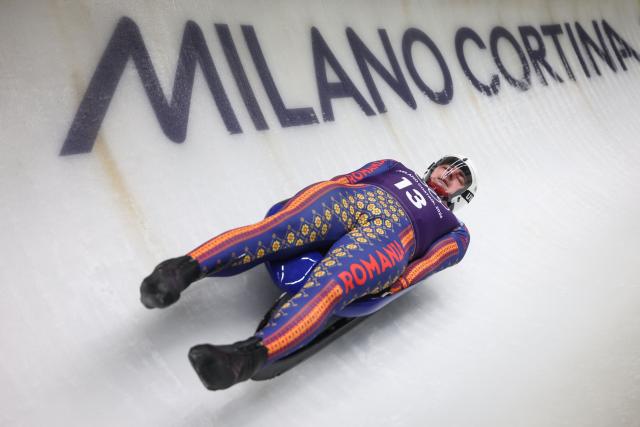 Romania's Valentin Cretu takes part in the luge men's singles training session at Cortina Sliding Centre during the Milano Cortina 2026 Winter Olympic Games in Cortina d'Ampezzo on February 4, 2026. (Photo by FRANCK FIFE / AFP)