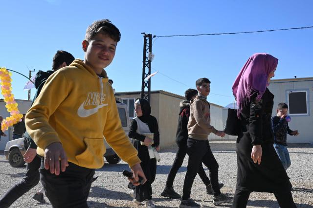Children return from shcool at the Imam Ali Housing Compound, where displaced Lebanese and Syrian refugee Shiite Muslims take refuge by the city of Hermel in Lebanon's northeastern Bekaa valley on February 4, 2026. (Photo by Joseph EID / AFP)