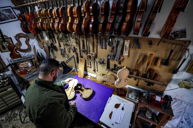 Palestinian musical instrument maker Shehada Shalalda assembles a violin under construction at his workshop in Ramallah in the occupied West Bank on February 4, 2026. (Photo by Zain JAAFAR / AFP)
