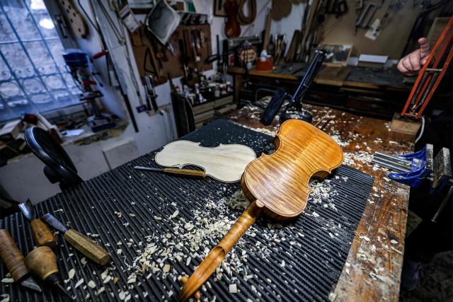 A partially-constructed violin is pictured in the workshop of Palestinian musical instrument maker Shehada Shalalda in Ramallah in the occupied West Bank on February 4, 2026. (Photo by Zain JAAFAR / AFP)