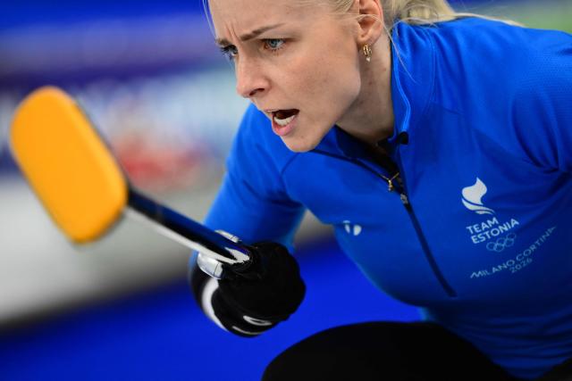 Estonia's Marie Kaldvee competes in the curling mixed doubles round robin between Estonia and Switzerland during the Milano Cortina 2026 Winter Olympic Games at the Cortina Curling Olympic Stadium in Cortina d’Ampezzo on February 4, 2026. (Photo by Marco BERTORELLO / AFP)