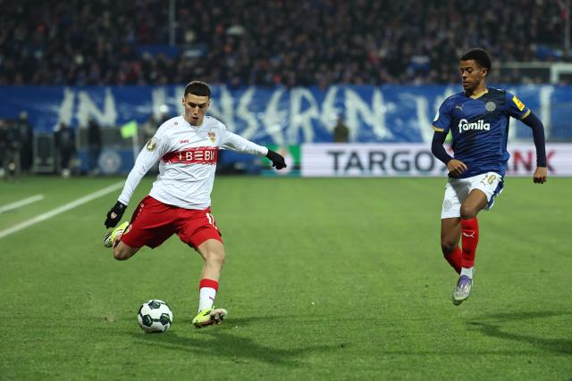Stuttgart's German-Marrocan forward #11 Bilal El Khannouss (L) and Holstein Kiel's Slovenian forward #19 Aldin Kajupovic vie for the ball during the German Cup (DFB-Pokal) quartefinal football match between Holstein Kiel and VfB Stuttgart in Kiel, northern Germany on February 4, 2026. (Photo by IBRAHIM OT / AFP) / DFB REGULATIONS PROHIBIT ANY USE OF PHOTOGRAPHS AS IMAGE SEQUENCES AND QUASI-VIDEO.
