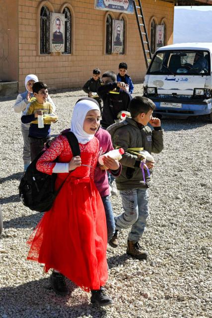 Children return from school at the Imam Ali Housing Compound, where displaced Lebanese and Syrian refugee Shiite Muslims take refuge by the city of Hermel in Lebanon's northeastern Bekaa valley on February 4, 2026. (Photo by Joseph EID / AFP)