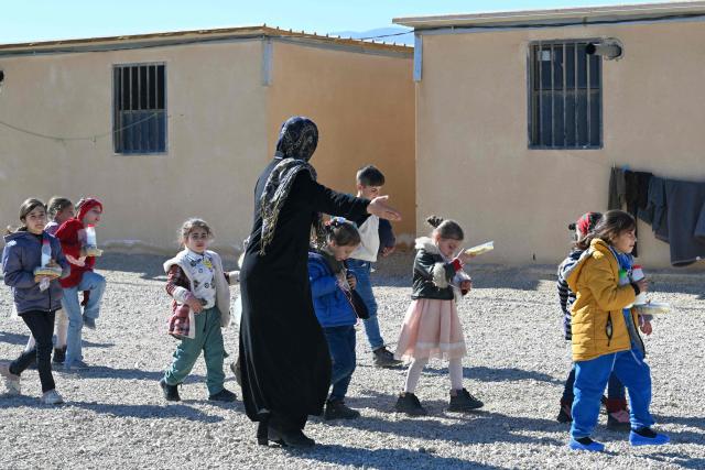 Children return from school at the Imam Ali Housing Compound, where Lebanese and Syrian Shiite Muslims displaced from Syria took refuge in the Lebanese City of Hermel in the Bekaa, northeast Lebanon,on February 4, 2026. at the Imam Ali Housing Compound, where displaced Lebanese and Syrian refugee Shiite Muslims take refuge by the city of Hermel in Lebanon's northeastern Bekaa valley on February 4, 2026. (Photo by Joseph EID / AFP)