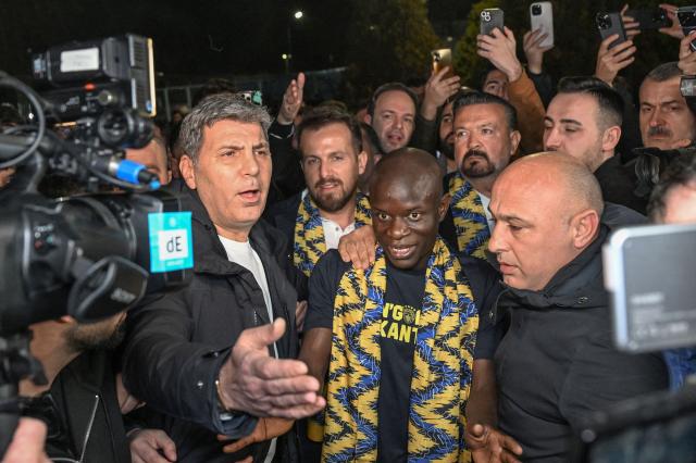 France midfielder Ngolo Kante (C) arrives at Sabiha Gokcen Airport to complete his transfer to Turkish football club Fenerbahce, in Istanbul on February 4, 2026. France midfielder Ngolo Kante has signed for Fenerbahce from Saudi side Al-Ittihad thanks to "support" from Turkey's President Recep Tayyip Erdogan, the Turkish club said on February 4, 2026. (Photo by Ozan KOSE / AFP)