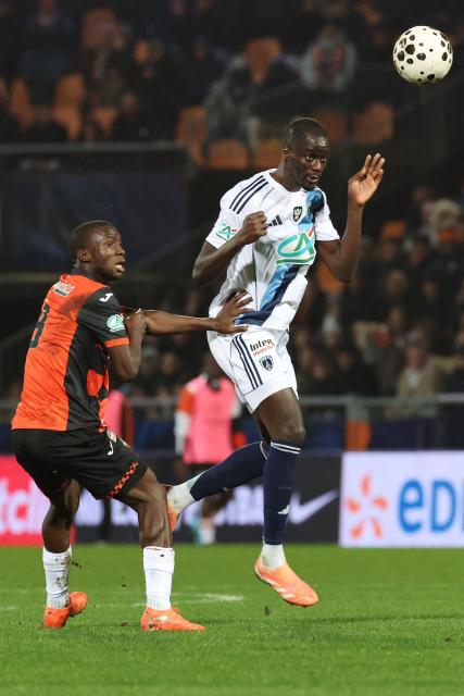 Paris FC's Senegalese defender #05 Moustapha Mbow (R) heads the ball in front of Lorient's Senegalese forward #09 Sambou Soumano (L) during the French Cup round of 16 football match between Lorient FC and Paris FC at the Stade du Moustoir in Lorient on February 4, 2026. (Photo by Fred TANNEAU / AFP)