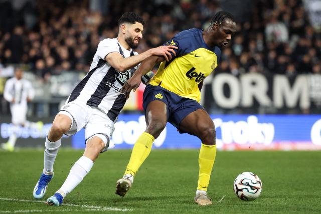 Royale Union Saint-Gilloise's Canadian forward #12 Promise David (R) and Royal Charleroi SC's Syrian defender #04 Aiham Ousou (L) fight for the ball during the semi final first leg of the Belgium 'Croky Cup' between Sporting Charleroi and Royale Union Saint-Gilloise at the Stade du Pays de Charleroi, in Charleroi, on February 4, 2026. (Photo by VIRGINIE LEFOUR / Belga / AFP) / Belgium OUT