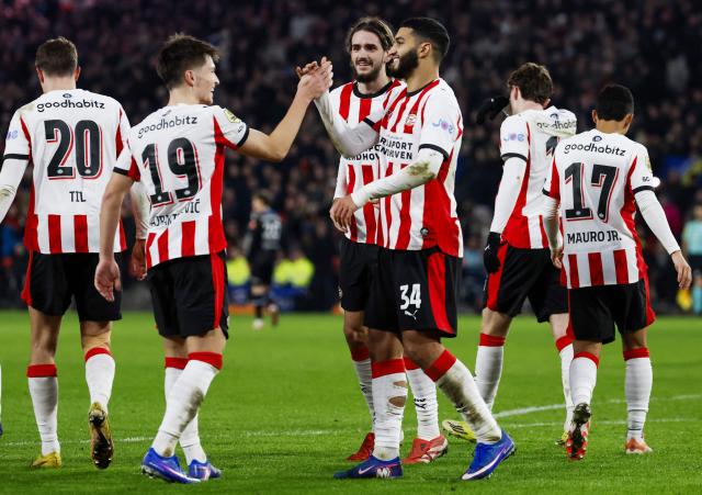 PSV Eindhoven's Bosnian forward #19 Esmir Bajraktarevic (2L) celebrates with teammates after scoring a goal during the KNVB Cup quarterfinal football match between PSV Eindhoven and SC Heerenveen at the Philips Stadium in Eindhoven on February 4, 2026. (Photo by Bas Czerwinski / ANP / AFP) / Netherlands OUT