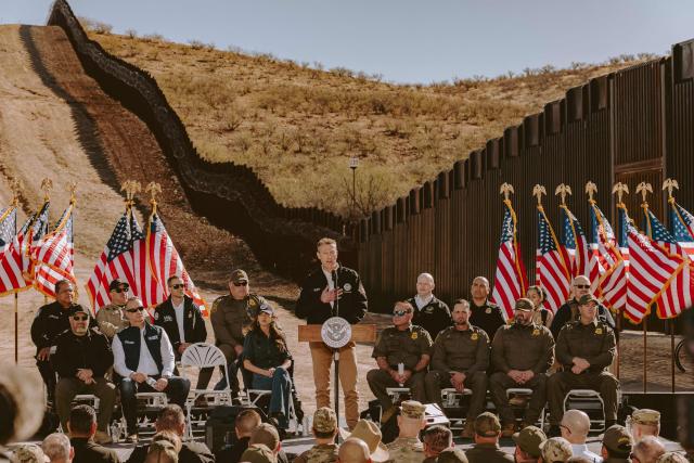 Rodney Scott, commissioner of the US Customs and Border Protection, speaks as US Homeland Security Secretary Kristi Noem (C, L) looks on during a press conference by the wall at the US-Mexico border in Nogales, Arizona, on February 4, 2026. (Photo by Olivier Touron / AFP)