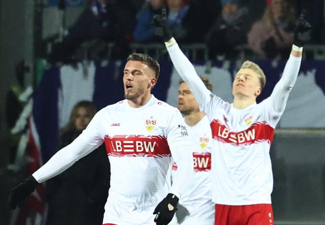 Stuttgart's German midfielder #10 Chris Fuehrich (R) celebrates with team mates after scoring the 0-2 goal during the German Cup (DFB-Pokal) quartefinal football match between Holstein Kiel and VfB Stuttgart in Kiel, northern Germany on February 4, 2026. (Photo by IBRAHIM OT / AFP) / DFB REGULATIONS PROHIBIT ANY USE OF PHOTOGRAPHS AS IMAGE SEQUENCES AND QUASI-VIDEO.