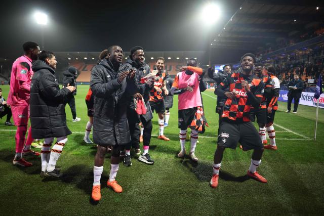 Lorient's players celebrate their victory at the end of the French Cup round of 16 football match between Lorient FC and Paris FC at the Stade du Moustoir in Lorient on February 4, 2026. (Photo by Fred TANNEAU / AFP)