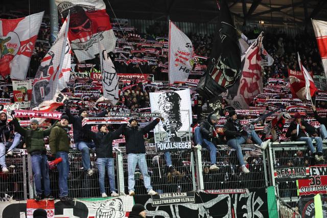 Stuttgart fans cheer for their team during the German Cup (DFB-Pokal) quartefinal football match between Holstein Kiel and VfB Stuttgart in Kiel, northern Germany on February 4, 2026. (Photo by Ibrahim OT / AFP) / DFB REGULATIONS PROHIBIT ANY USE OF PHOTOGRAPHS AS IMAGE SEQUENCES AND QUASI-VIDEO.