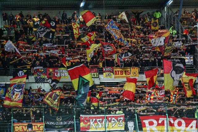 Lens' cheer their team on from the stands during the French Cup round of 16 football match between Estac Troyes and Lens RC at the Stade de l'Aube in Troyes on February 4, 2026. (Photo by Sameer Al-DOUMY / AFP)