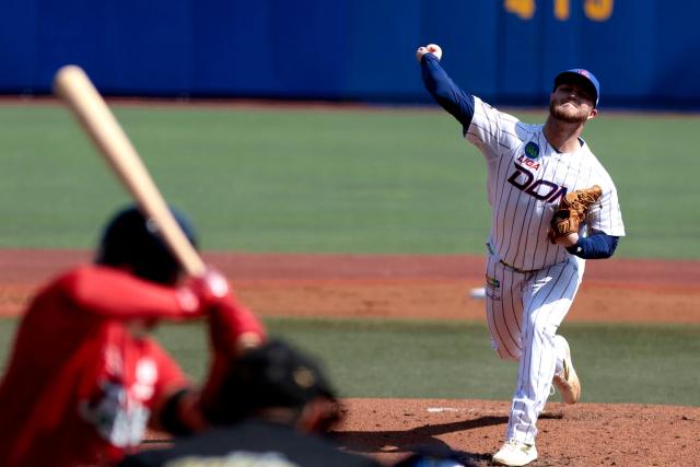 Leones del Escogido's #46 Travis Lakins pitches in the second inning of the Caribbean Series baseball tournament seventh game between Panama's Federales de Chiriqui and Dominican Republic's Leones del Escogido at the Panamerican Stadium in Jalisco, Mexico, on February 4, 2026. (Photo by Ulises Ruiz / AFP)