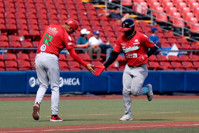 Federales de Chiriqui's #99 Jose Antonio Ramos (R) celebrates with Federales de Chiriqui's #22 Christian Bethancourt during the second inning of the seventh game of the Caribbean Series baseball tournament seventh game between Panama's Federales de Chiriqui and Dominican Republic's Leones del Escogido at the Panamerican Stadium in Jalisco, Mexico, on February 4, 2026. (Photo by Ulises Ruiz / AFP)