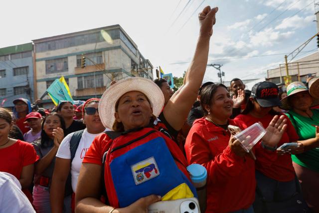 A woman gestures during a march by 'Chavismo' supporters to commemorate the 34th anniversary of a coup attempt by Hugo Chavez, in Maracay, Aragua state, Venezuela, on February 4, 2026. (Photo by Pedro MATTEY / AFP)