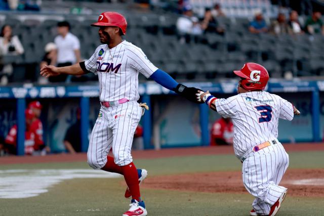 Leones del Escogido's #2 Gustavo Nunez celebrates with teammate during the fourth inning of the seventh game of the Caribbean Series baseball tournament seventh game between Panama's Federales de Chiriqui and Dominican Republic's Leones del Escogido at the Panamerican Stadium in Jalisco, Mexico, on February 4, 2026. (Photo by Ulises Ruiz / AFP)