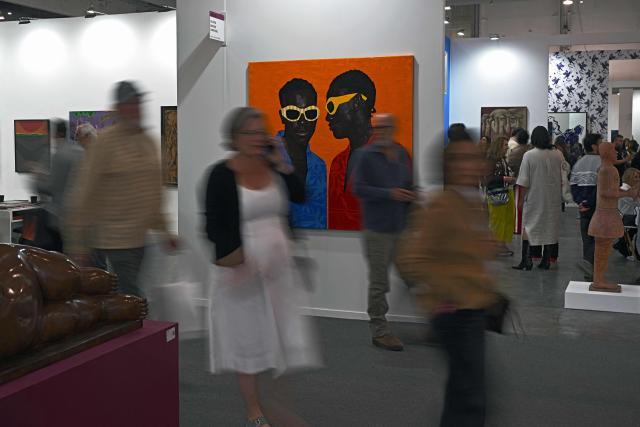 People attend the first day of Mexico Art Week, the largest art fair in Latin America, which draws artists and collectors from around the world, in Mexico City on February 4, 2026. The annual fair runs from February 4 to February 8, 2026. (Photo by Carl de Souza / AFP)