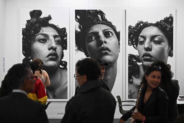 People attend the first day of Mexico Art Week, the biggest Art fair in Latin America, drawing artists and collectors from all over the world in Mexico City on February 4, 2026. The annual fair runs from February 4 until February 8 2026. (Photo by Carl de Souza / AFP)