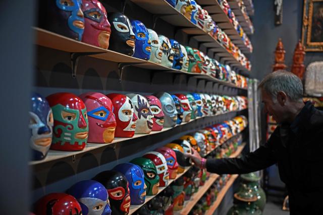 A selection of Lucha Libra busts are seen on the first day of Mexico Art Week, the biggest Art fair in Latin America, drawing artists and collectors from all over the world in Mexico City on February 4, 2026. The annual fair runs from February 4 until February 8, 2026. (Photo by Carl de Souza / AFP)