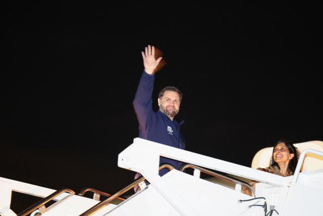 Second Lady Usha Vance smiles as her husband US Vice President JD Vance waves as they board Air Force Two for the Milano Cortina 2026 Winter Olympics in Italy, from Joint Base Andrews, Maryland, on February 4, 2026. (Photo by Kevin Lamarque / POOL / AFP)